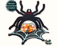 a spider with a bowl of candy in it