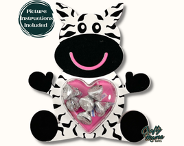 a stuffed zebra holding a heart filled with candy