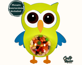 a green owl with a bowl of candy in it's mouth