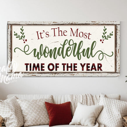 It&#39;s the most wonderful time of the year sign in a living room with a couch and christmas decorations