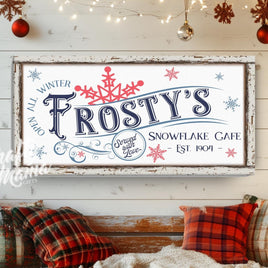 snowflake cafe sign hanging on a porch decorated for Christmas