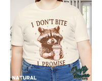 a woman wearing a white shirt with a raccoon on it