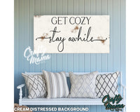 a sign that says get cozy stay awhile