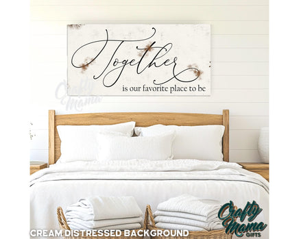 a bed with white sheets and pillows and a wooden sign above it