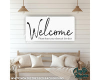 a welcome sign hanging on the wall of a living room