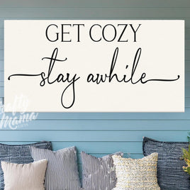 a sign that says get cozy stay awhile