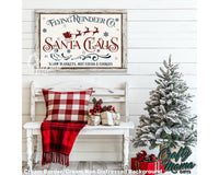 Flying reindeer canvas sign above a white bench sitting next to a christmas tree