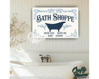 a bath shoppe sign hanging on a wall above a bathtub