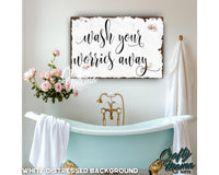 a bathroom with a bathtub and a sign that says wash your hands away