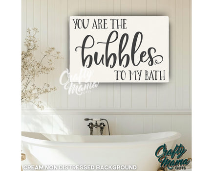 a bathroom with a tub and a sign that says you are the bubbles to my