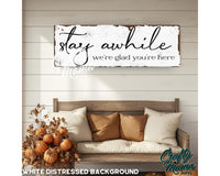 a wooden sign that says stay awhile, we&#39;re glad you&#39;re here