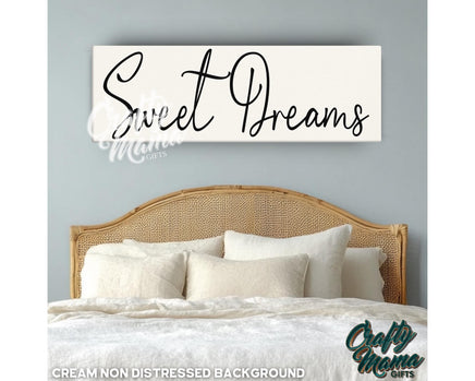 a bedroom with a bed and a sign that says sweet dreams