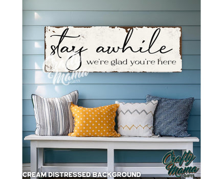 a wooden sign that says stay awhile, we&#39;re glad you&#39;re here