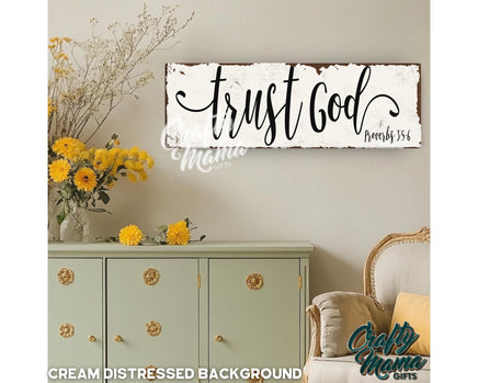 a sign that says trust god and a vase with yellow flowers