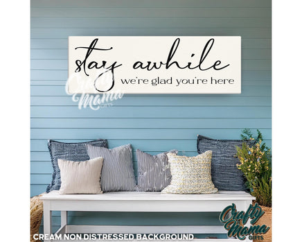 a bench with pillows and a sign that says stay awhile we&#39;re glad you