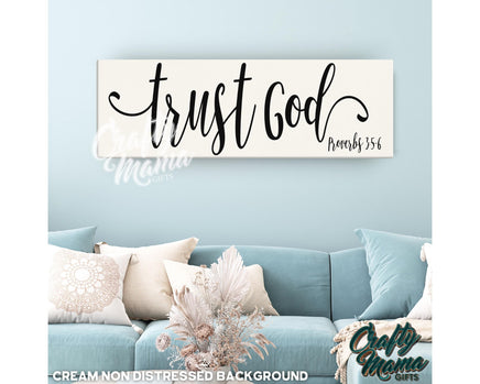 a living room with a blue couch and a white sign that says trust god