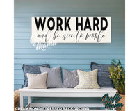 a bench with pillows and a sign that says work hard and be nice to people