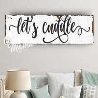 a living room filled with furniture and a sign that says let&#39;s cuddle