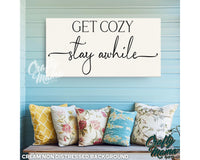 a sign that says get cozy stay awhile