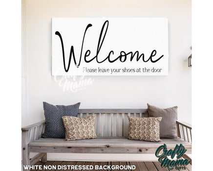 a wooden bench sitting under a welcome sign