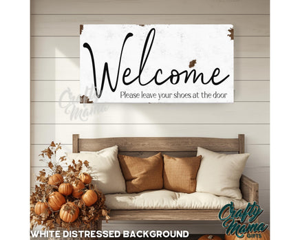 a welcome sign hanging on a wall next to a couch