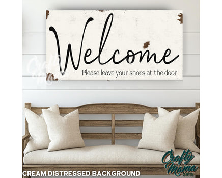 a welcome sign hanging on a wall above a couch