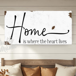 a picture of a couch with pillows and a sign that says home is where the