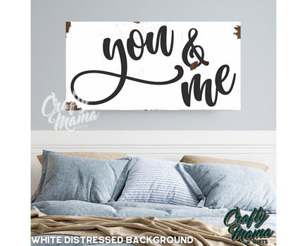 a bedroom with a bed and a sign that says you and me