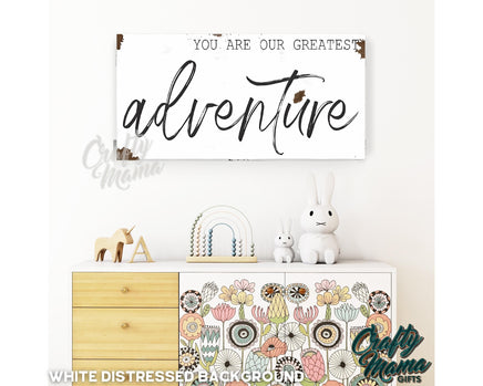 a white dresser with a sign above it that says, you are our greatest adventure