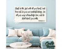 a living room with a blue couch and a quote on the wall