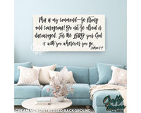 a living room with a blue couch and a quote on the wall