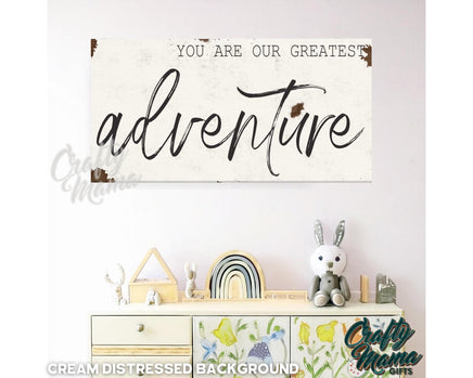 a wooden sign that says you are our greatest adventure