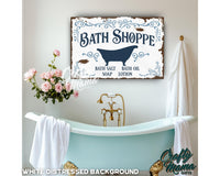 a bath shoppe sign hanging on the wall of a bathroom