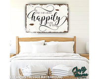 a bed with white sheets and pillows and a wooden sign above it