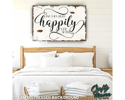 a bed with white sheets and pillows and a wooden sign above it