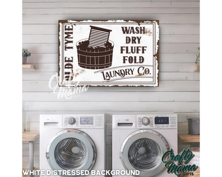 a laundry sign hanging on the wall above a washer and dryer