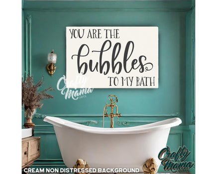 a bathroom with a tub and a sign that says you are the bubbles to my