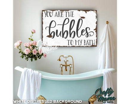 a bathroom with a tub and a sign that says you are the bubbles to my