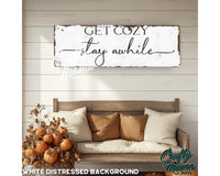 a wooden sign that says get cozy, stay awhile