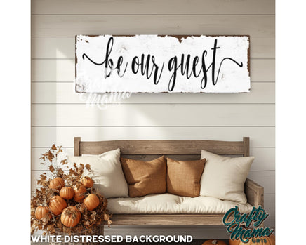 a wooden sign that says, be our guest white distressed background