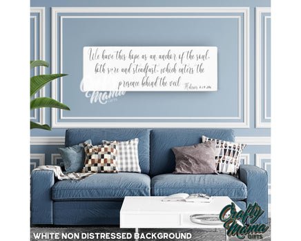 a living room with a blue couch and a quote on the wall