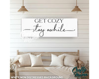 a sign that says get cozy stay awhile