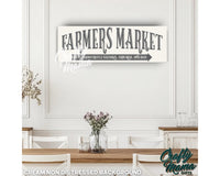 a sign that says farmers market hanging on a wall