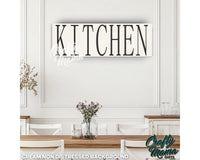 a kitchen sign hanging on the wall above a table