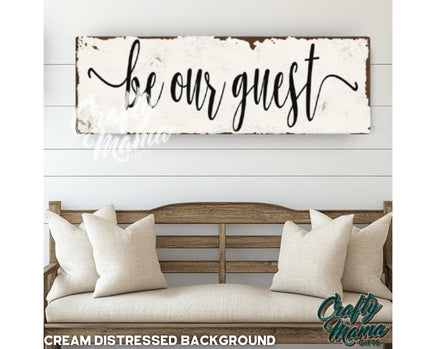 a wooden sign that says be our guest on it