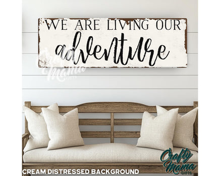 a wooden sign that says we are living our adventure