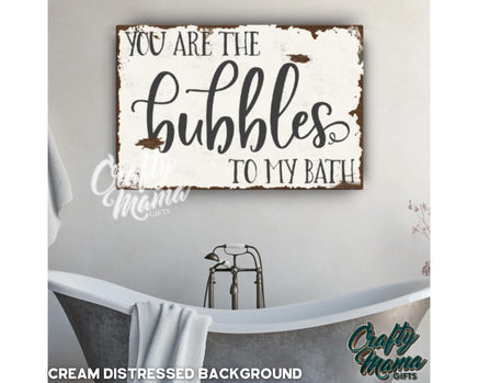 a bathroom with a tub and a sign that says you are the bubbles to my