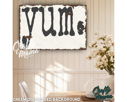 a sign that says yum hanging on a wall