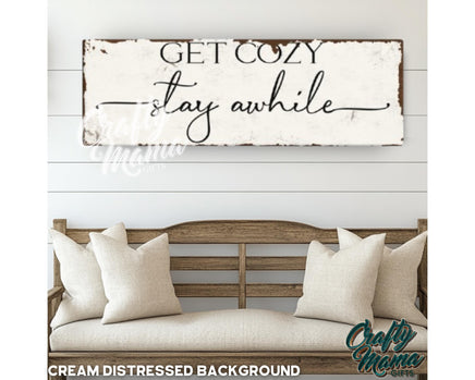 a wooden sign that says get cozy stay awhile