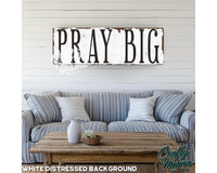 a wooden sign that says pray big on it